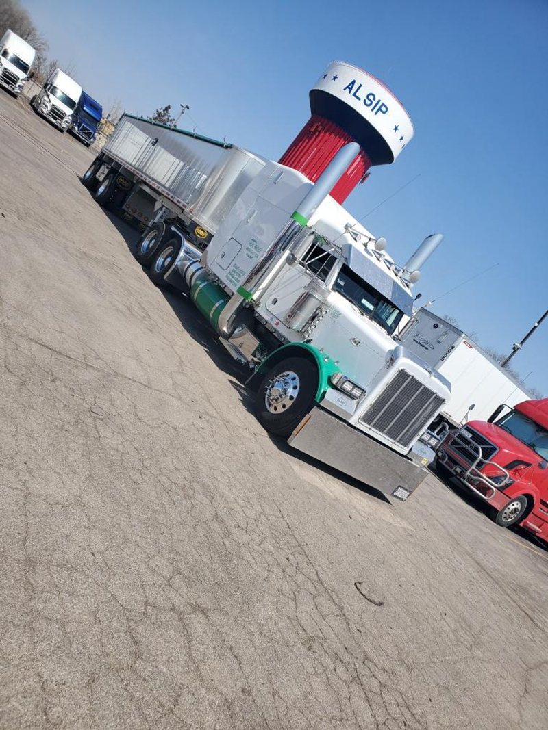 white end dump tractor trailer in parking lot